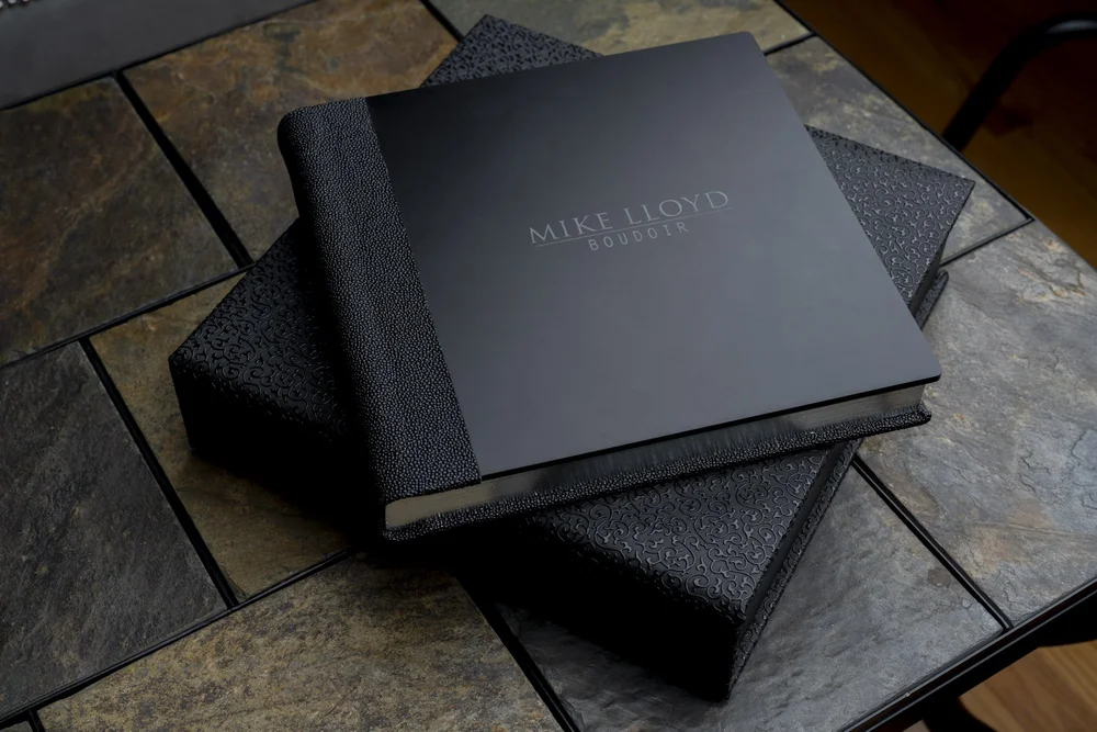 Mike Lloyd Boudoir heirloom albums and keepsake boxes on a slate table
