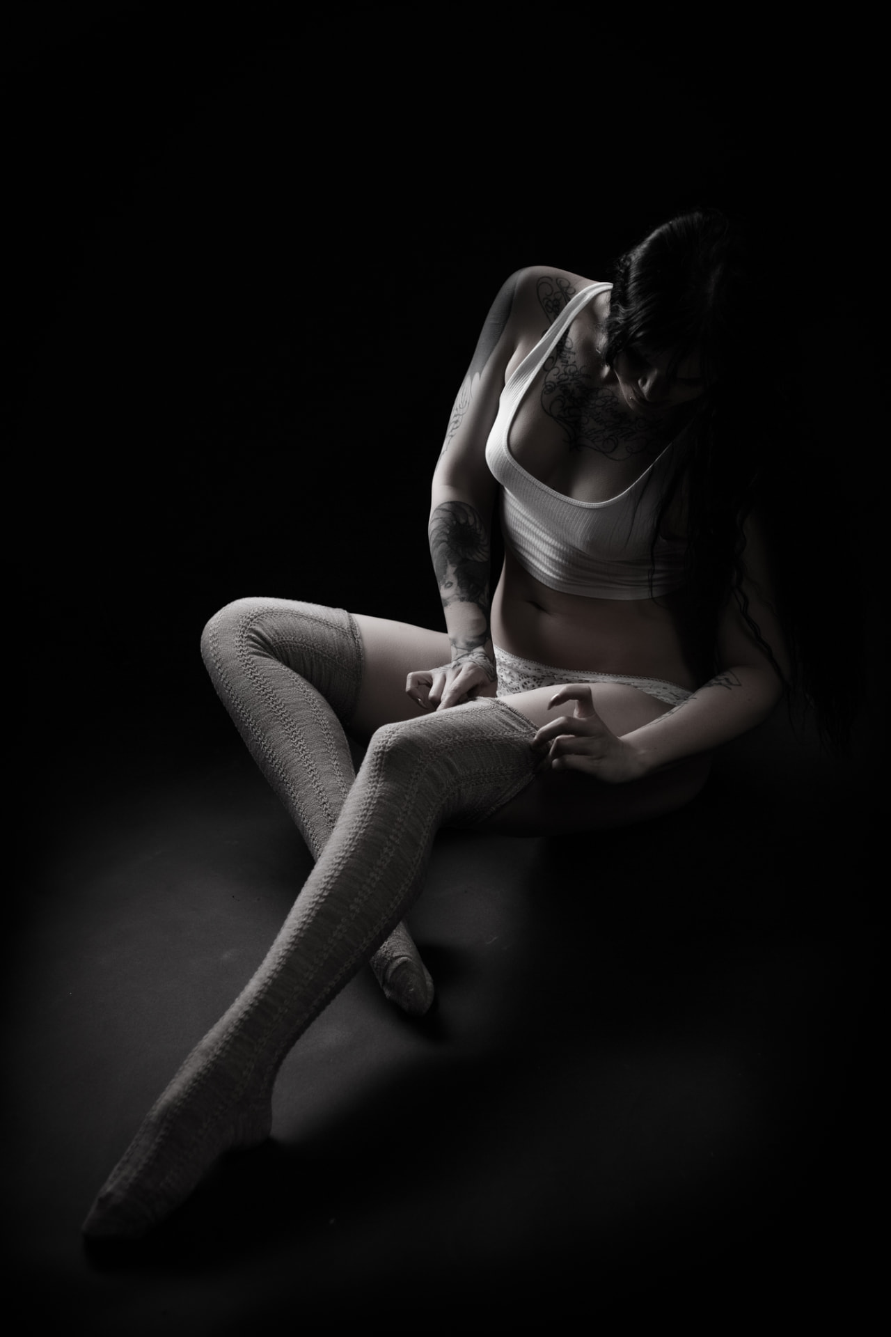 Vertical portrait of a woman styled for a luxury boudoir session